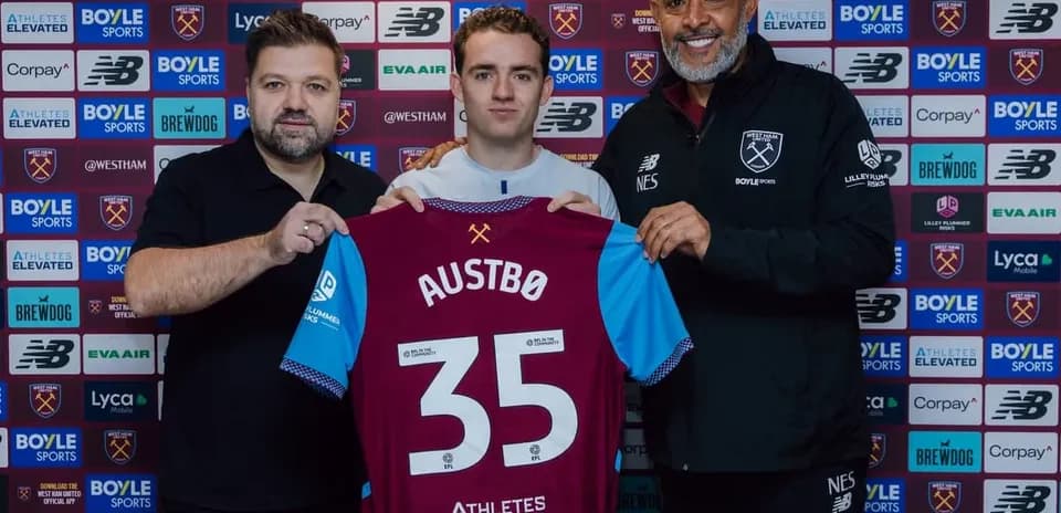 Player holding jersey with 'Austbø' during signing event