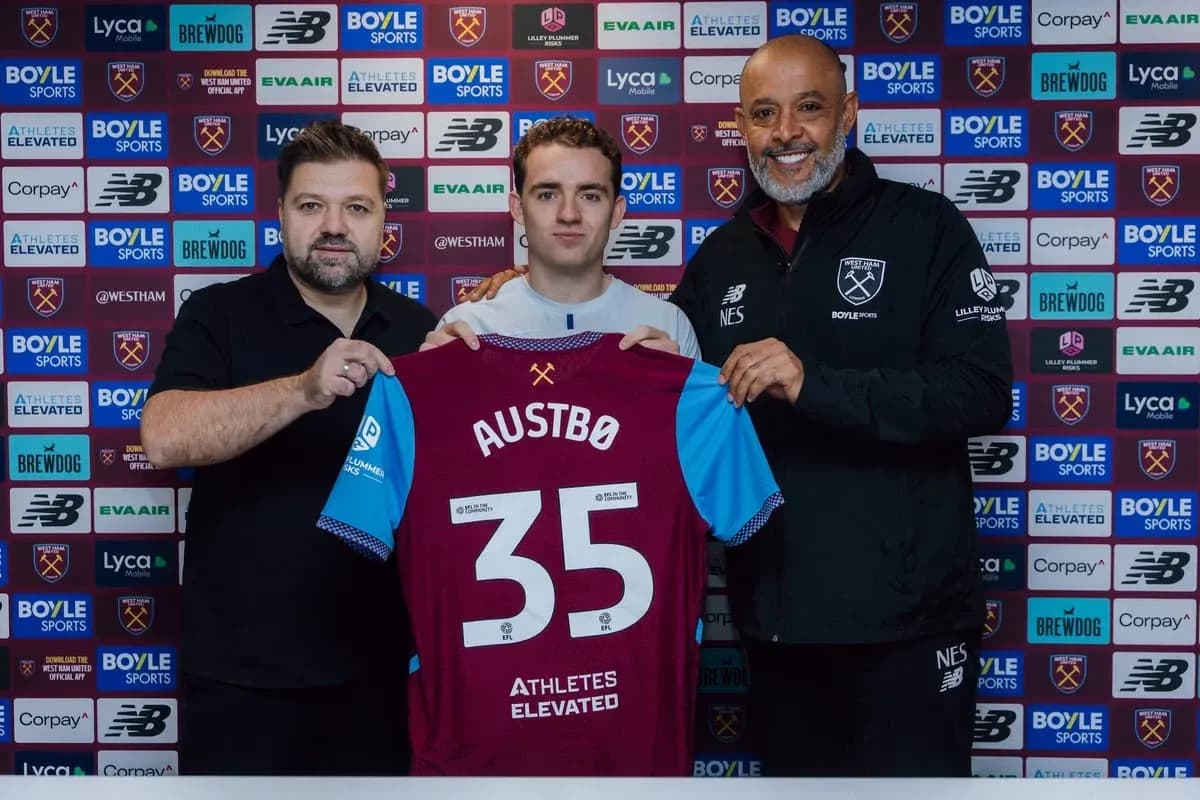 Player holding jersey with 'Austbø' during signing event