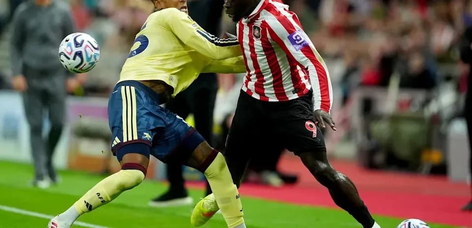 Two players contesting for the ball during match