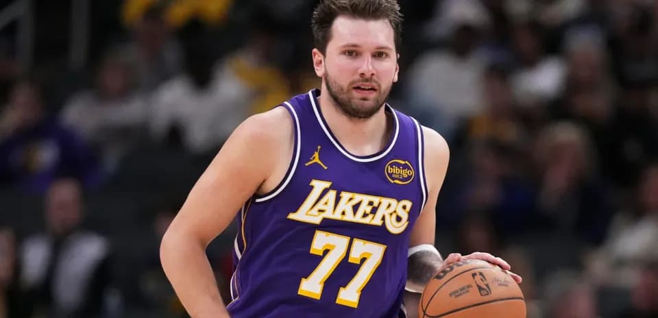 Player dribbling basketball in Lakers jersey