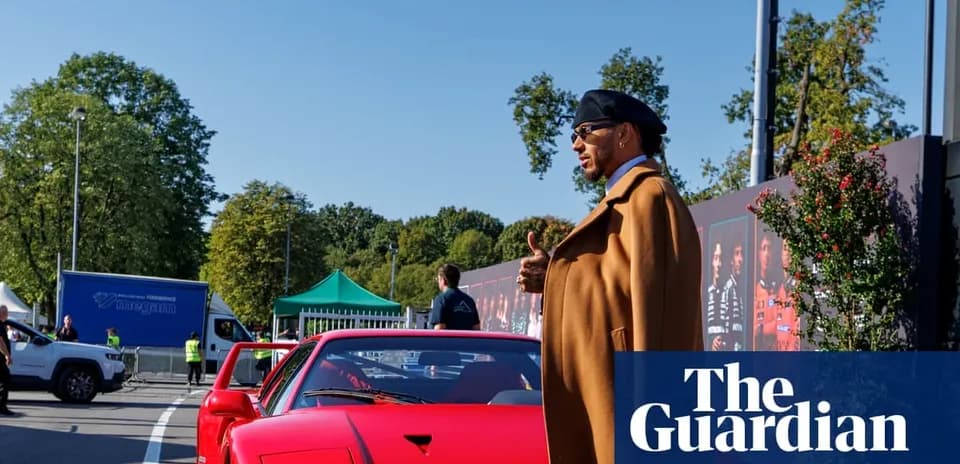 Person beside a red sports car at event