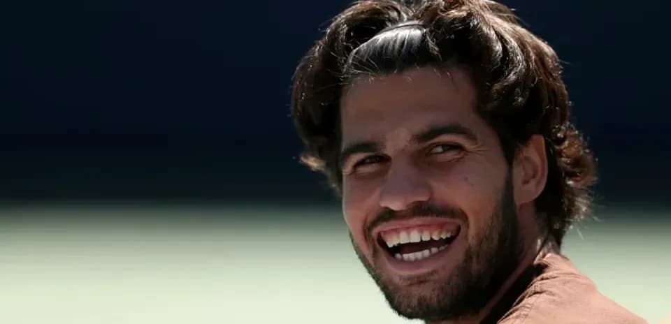 Tennis player smiling during practice session