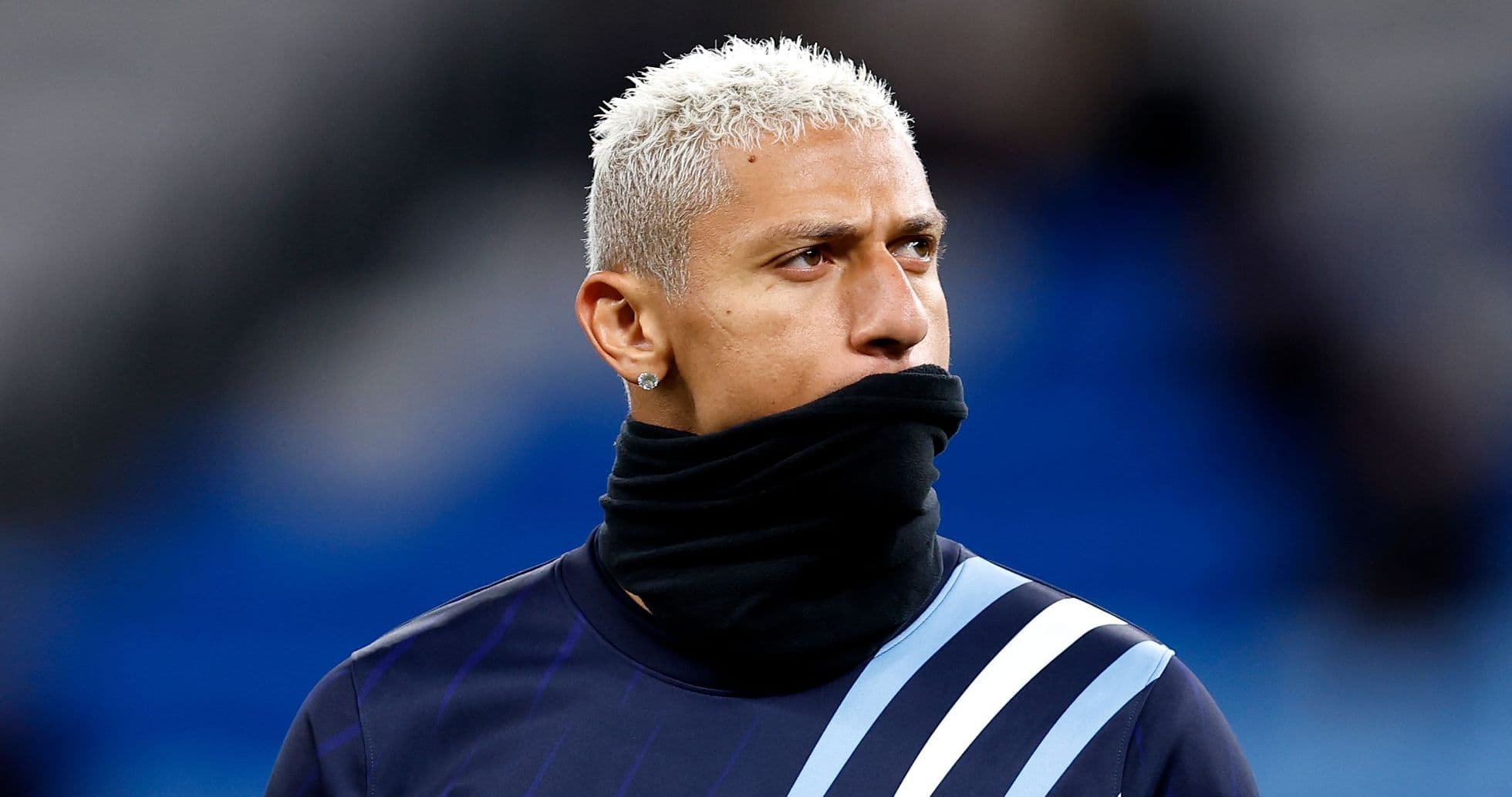 Player wearing a black scarf during warm-up
