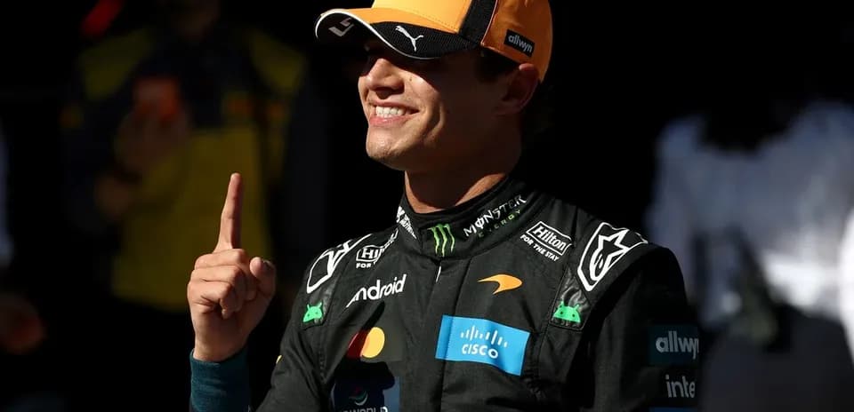 Driver celebrating with finger raised in McLaren suit