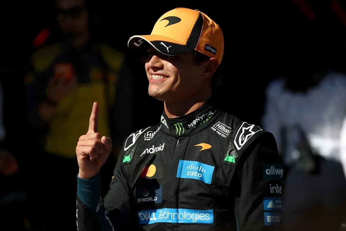 Driver celebrating with finger raised in McLaren suit