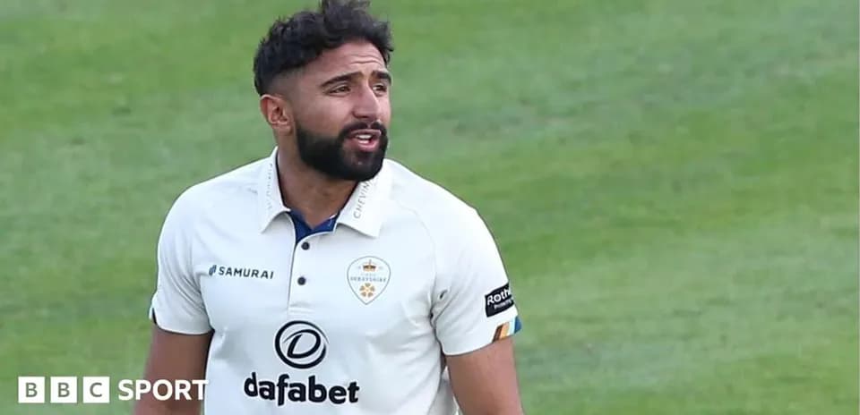 Cricketer in Derbyshire kit on the field
