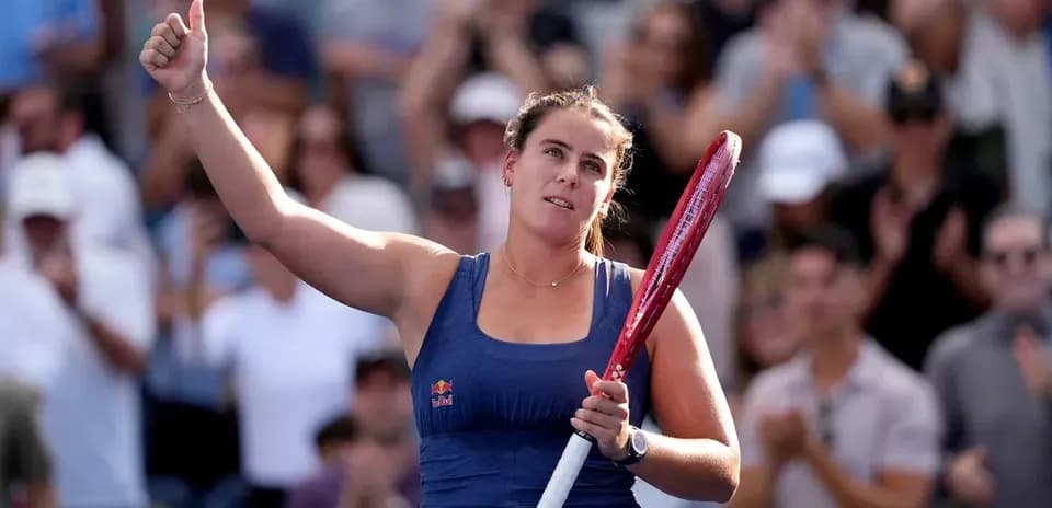 Player celebrating with raised hand and racket