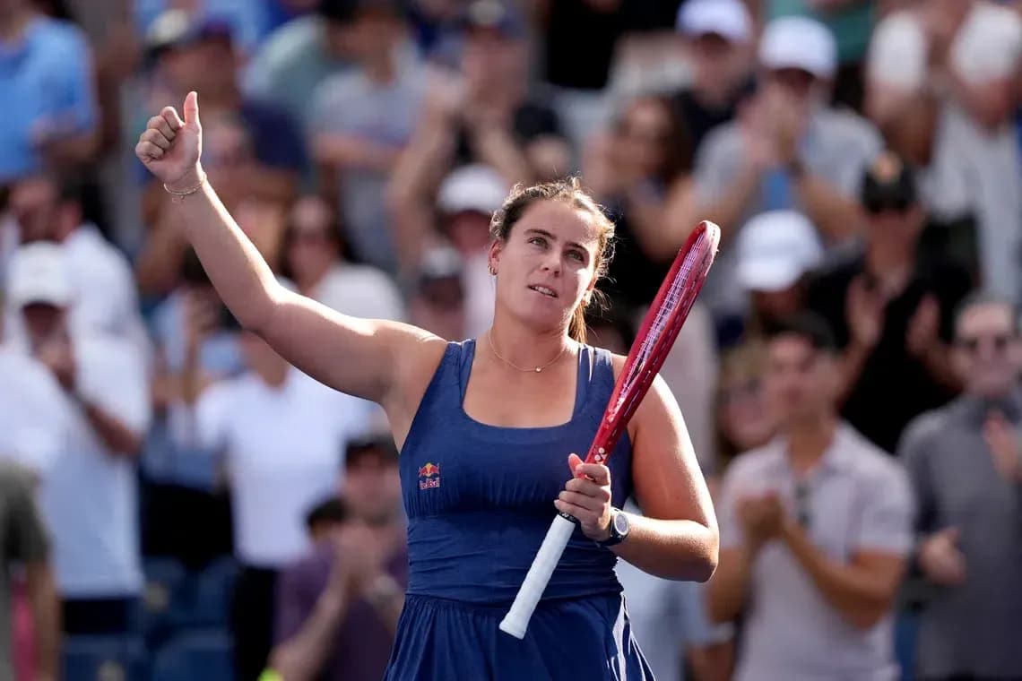 Player celebrating with raised hand and racket