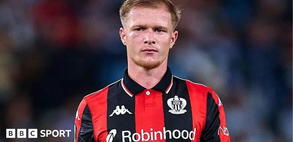 Player in black and red kit during match