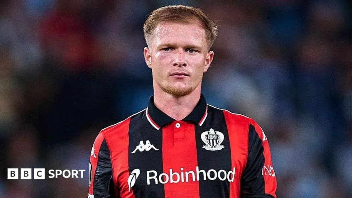 Player in black and red kit during match