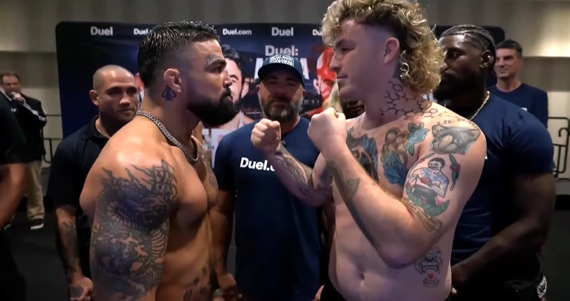 Two fighters facing off at weigh-in event