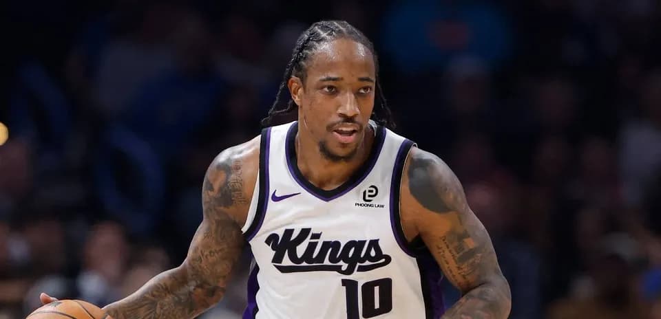 Player dribbling basketball in Kings uniform