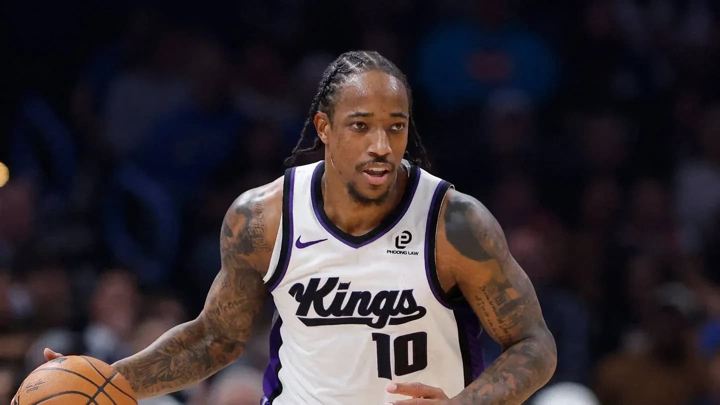 Player dribbling basketball in Kings uniform