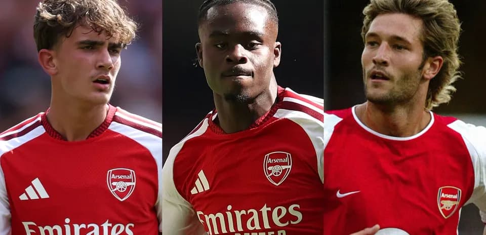 Three Arsenal players in red jerseys on field