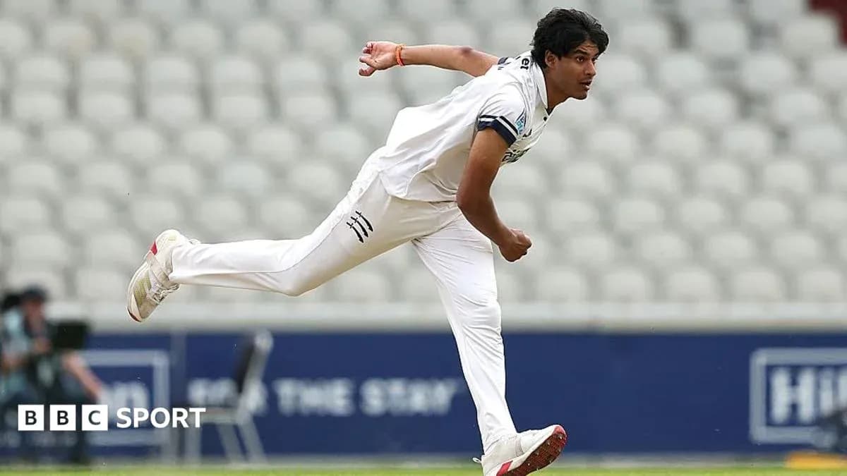 Cricketer bowling during a match at stadium