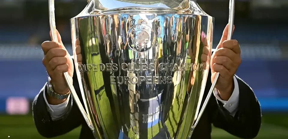 Champions League trophy held by an individual