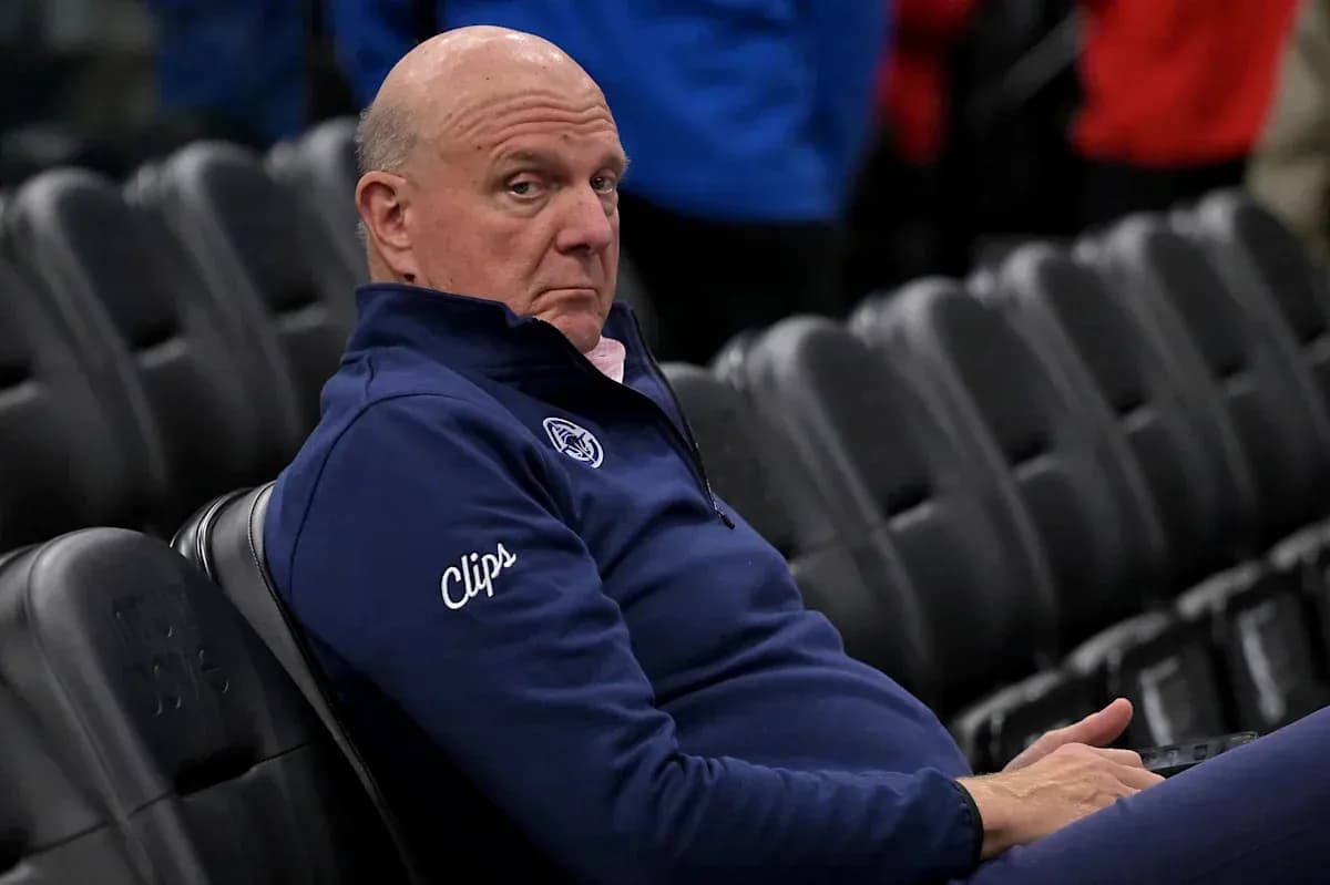 Person seated in arena wearing Clippers jacket