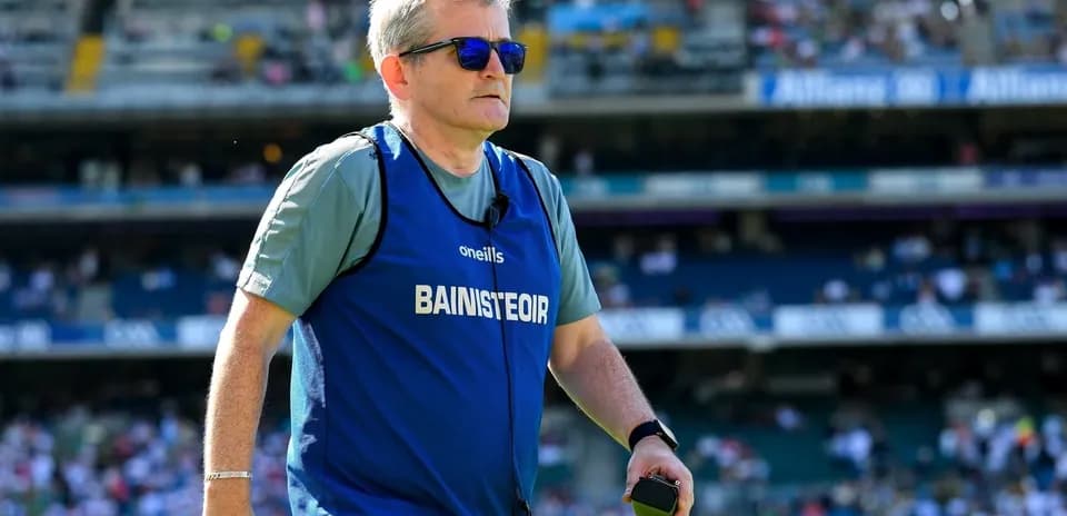 Coach walking on the field during warm-up