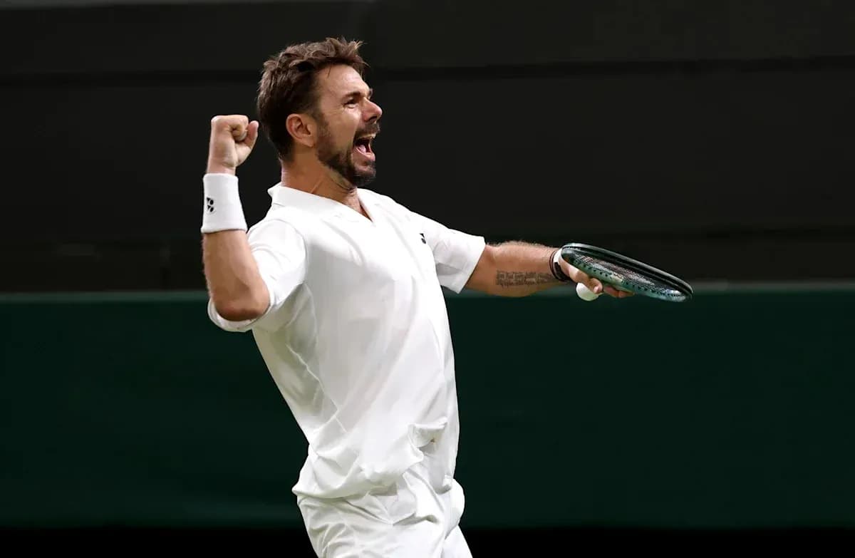 Tennis player celebrating victory with racket raised