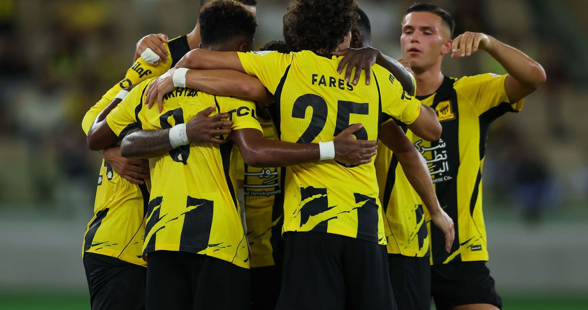 Team celebrating together in yellow and black jerseys