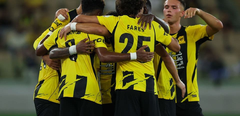 Team celebrating together in yellow and black jerseys