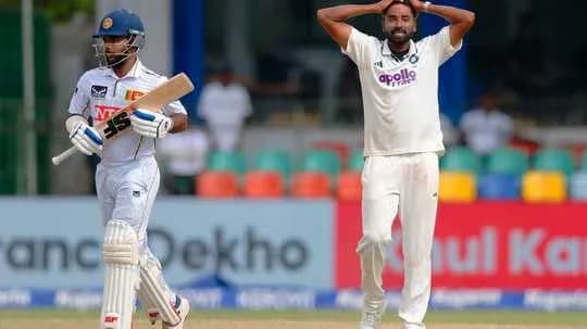 Bowler expressing frustration while batsman prepares to bat