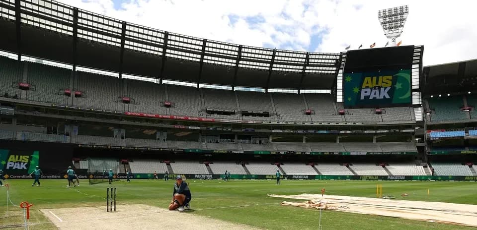 Cricket players training on the pitch at stadium