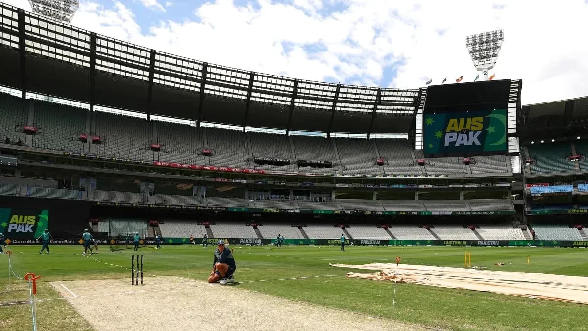 Cricket players training on the pitch at stadium