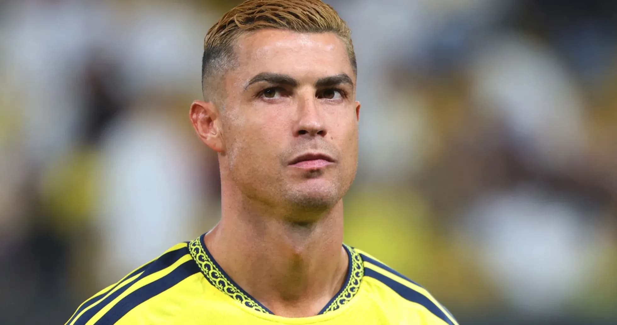 Player in yellow jersey during match preparation
