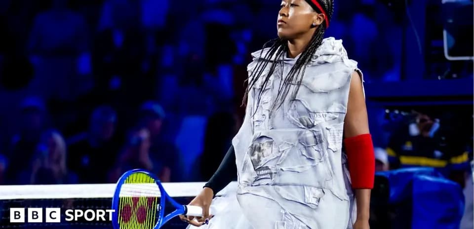 Naomi Osaka walking onto the court with tennis racket