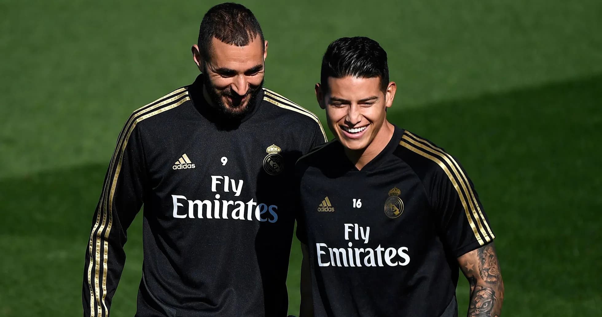 Two Real Madrid players smiling during training session