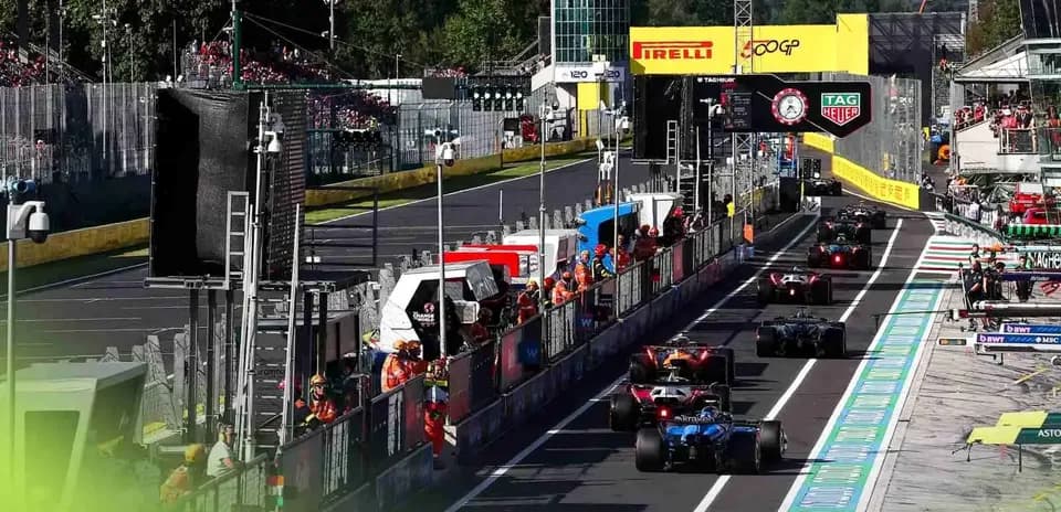 Formula 1 cars in pit lane during race