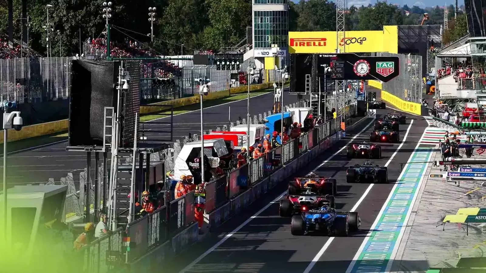 Formula 1 cars in pit lane during race