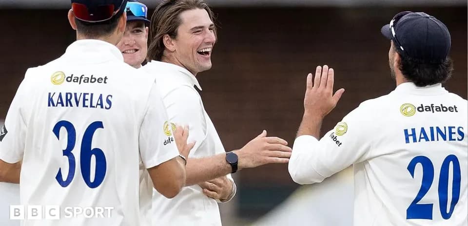 Cricket players celebrating a wicket on the field