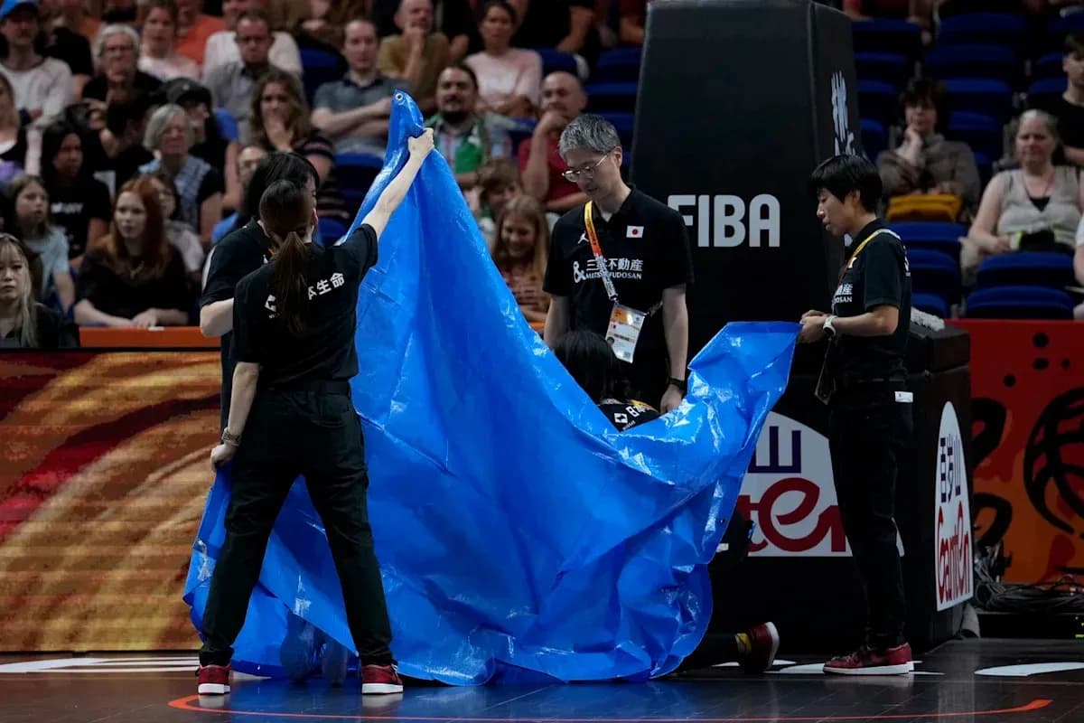 Staff covering the court with a blue tarp