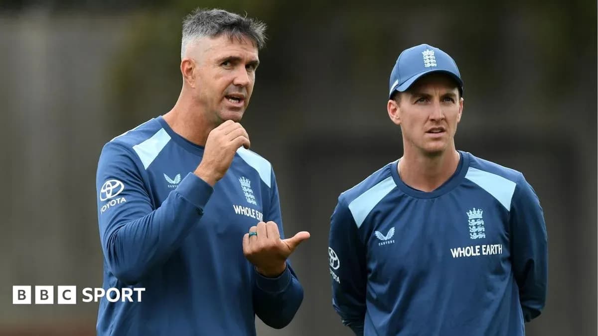 Coaches discussing strategy during cricket training session