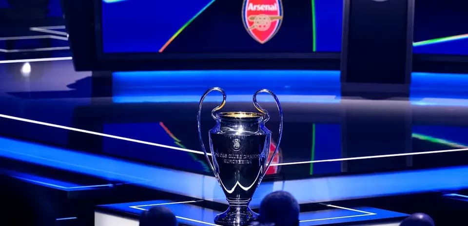Champions League trophy displayed with Arsenal logo