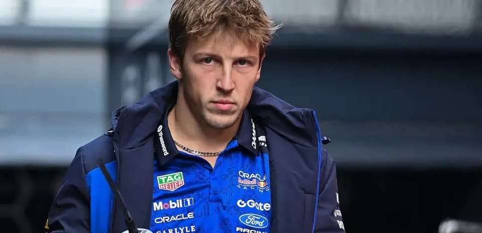 Driver wearing team jacket in paddock area