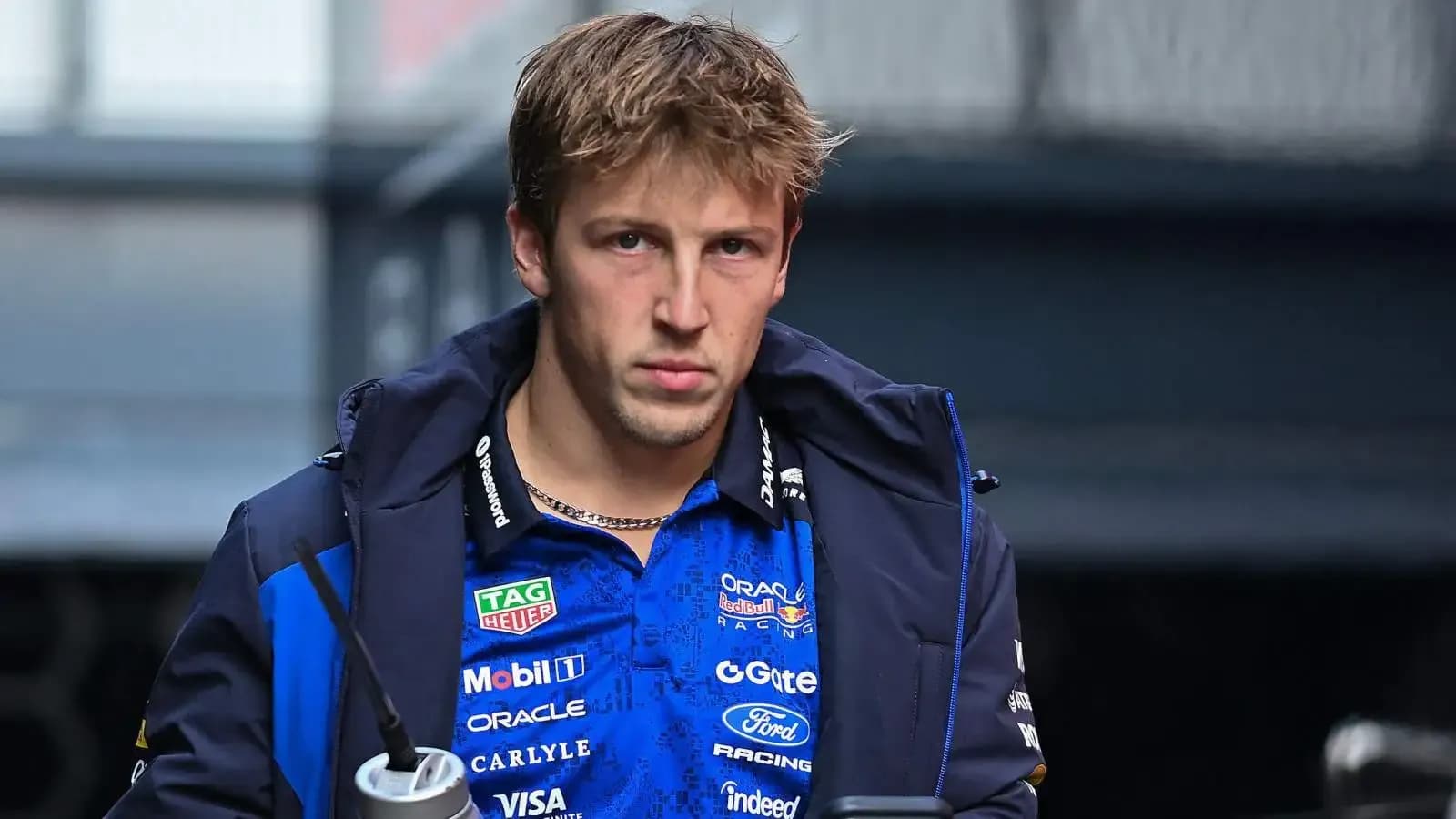 Driver wearing team jacket in paddock area