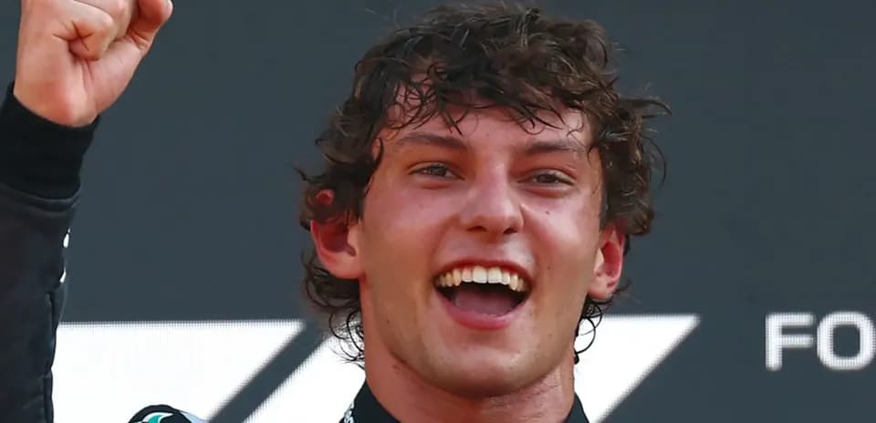 Racing driver celebrating victory with raised fist