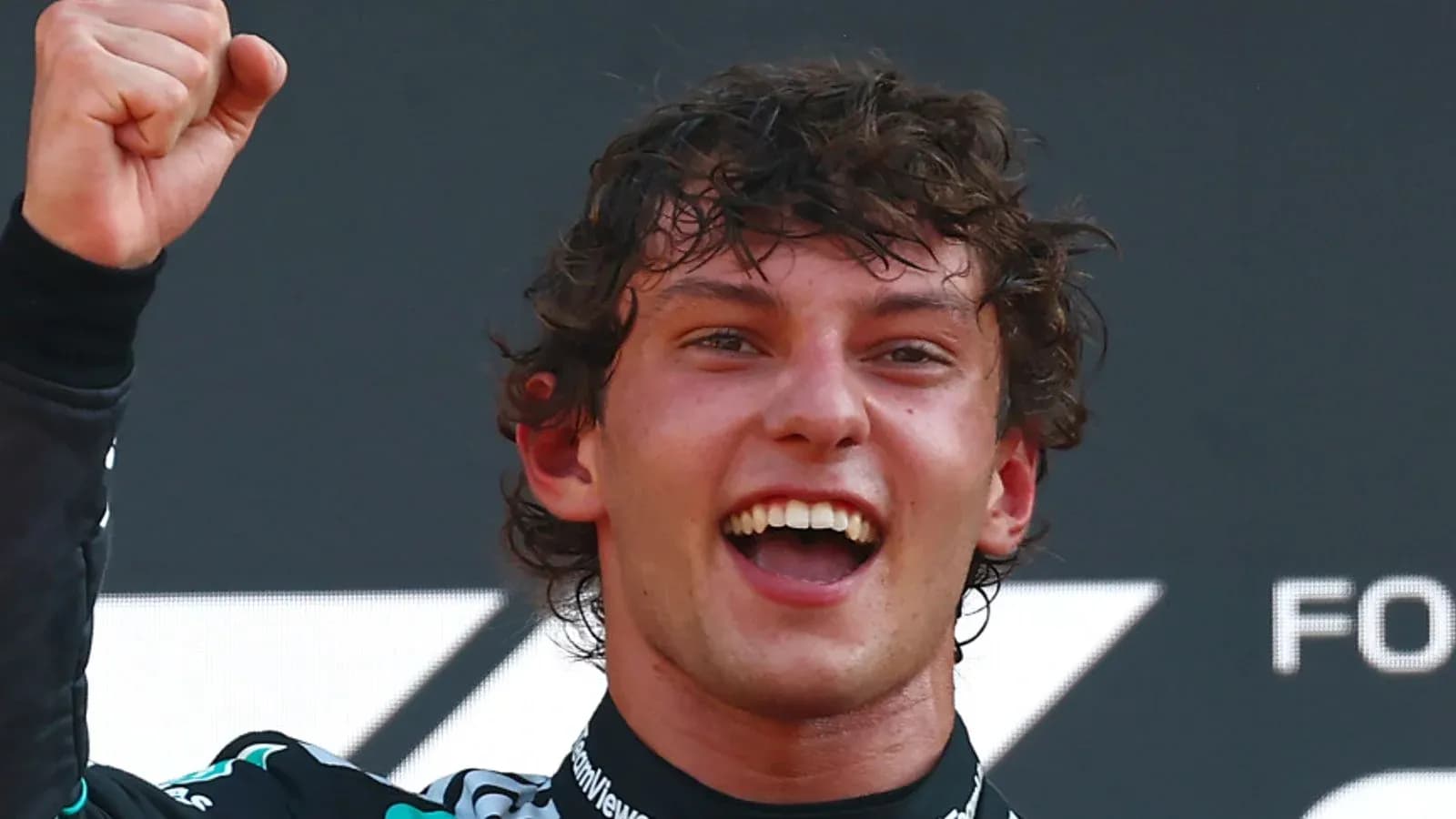 Racing driver celebrating victory with raised fist