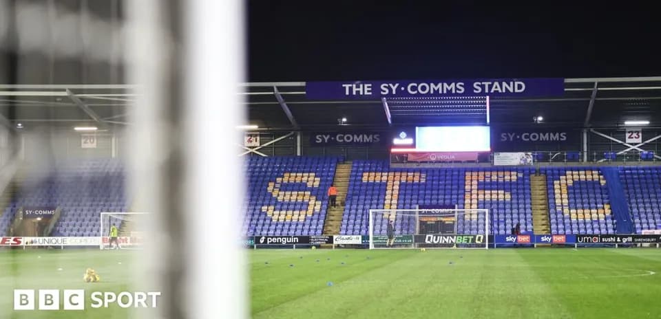 Shrewsbury Town's stadium with empty stands and goal