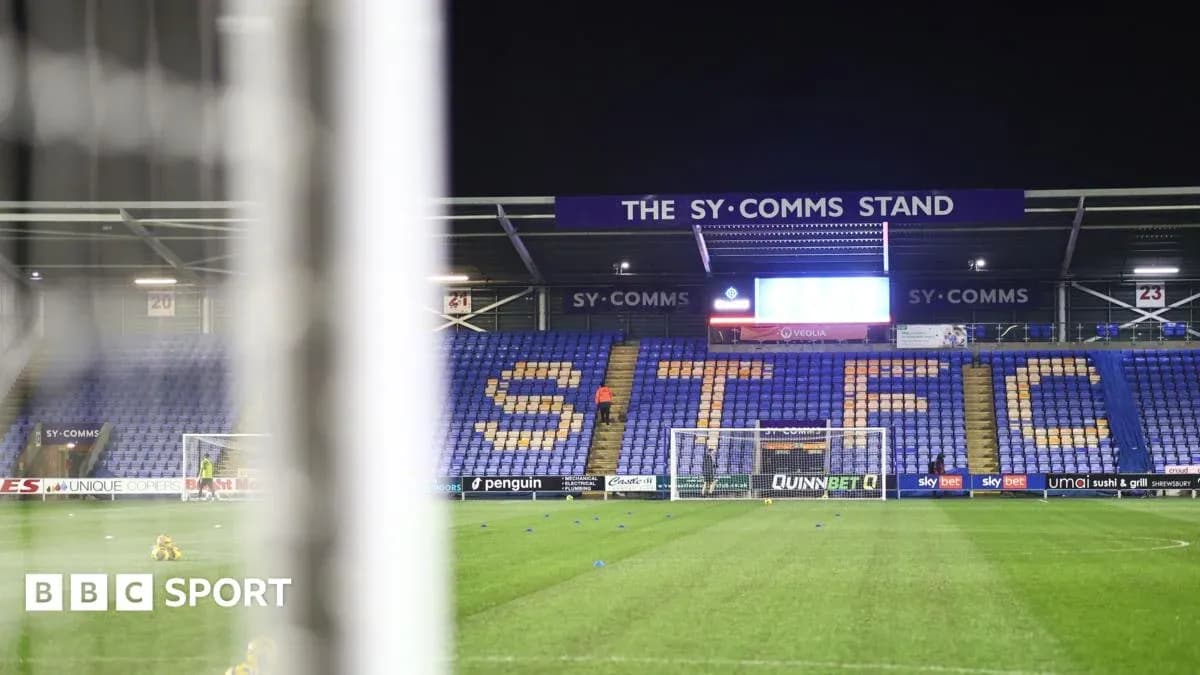 Shrewsbury Town's stadium with empty stands and goal