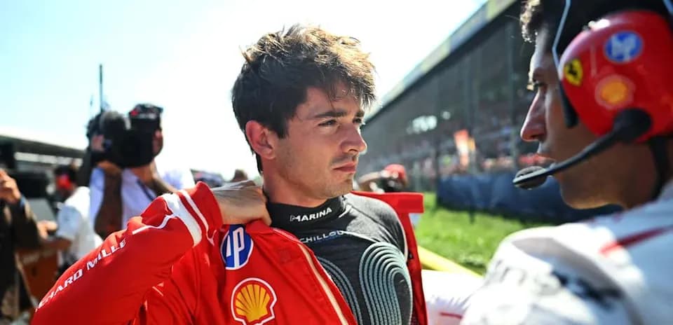 Driver preparing for race with team member assistance
