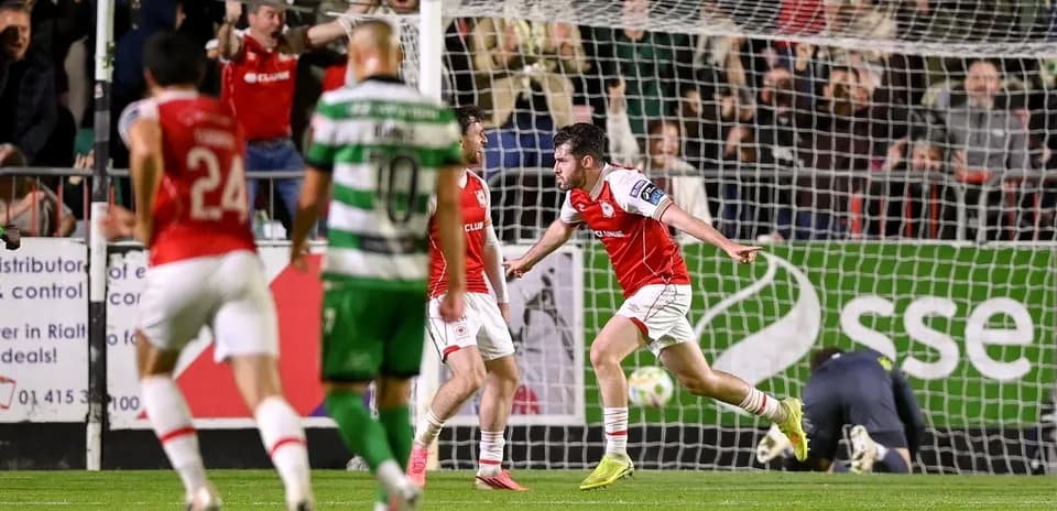 Player celebrating a goal with teammates during match