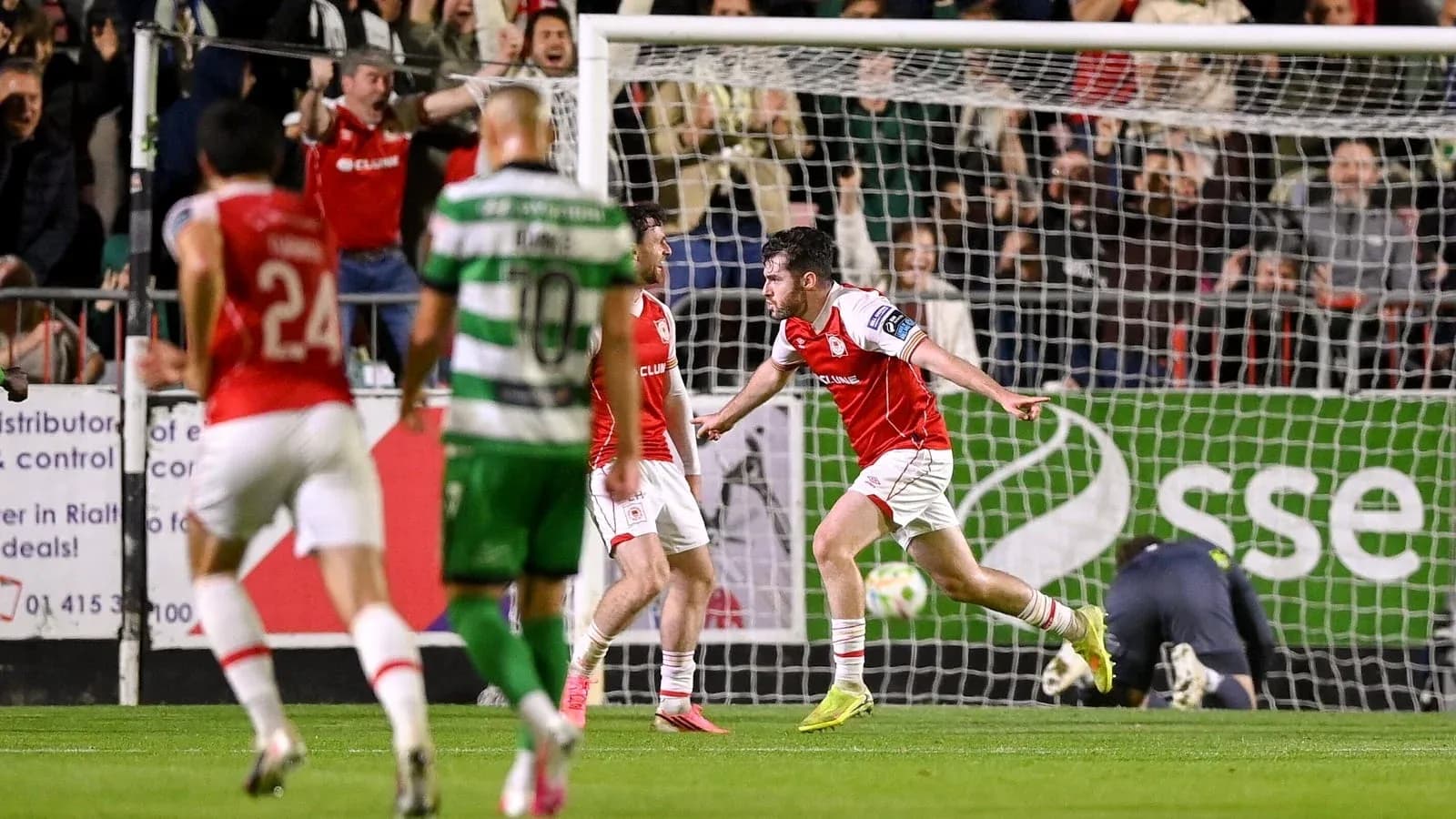 Player celebrating a goal with teammates during match
