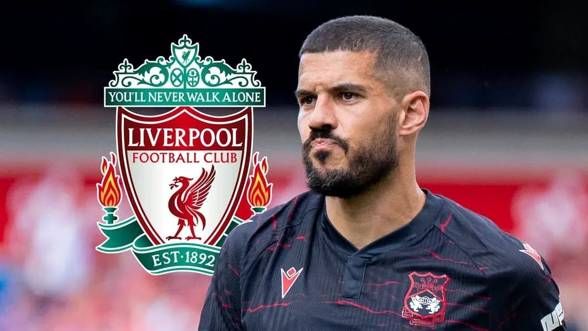 Player in black jersey with Liverpool logo in background