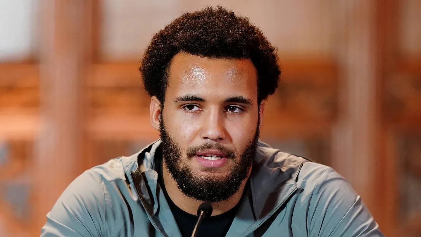 Athlete speaking at press conference with microphone