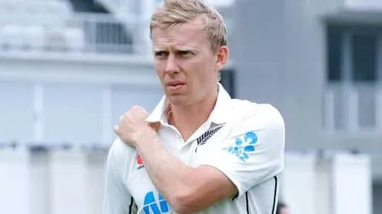 Cricketer adjusting his collar on the field