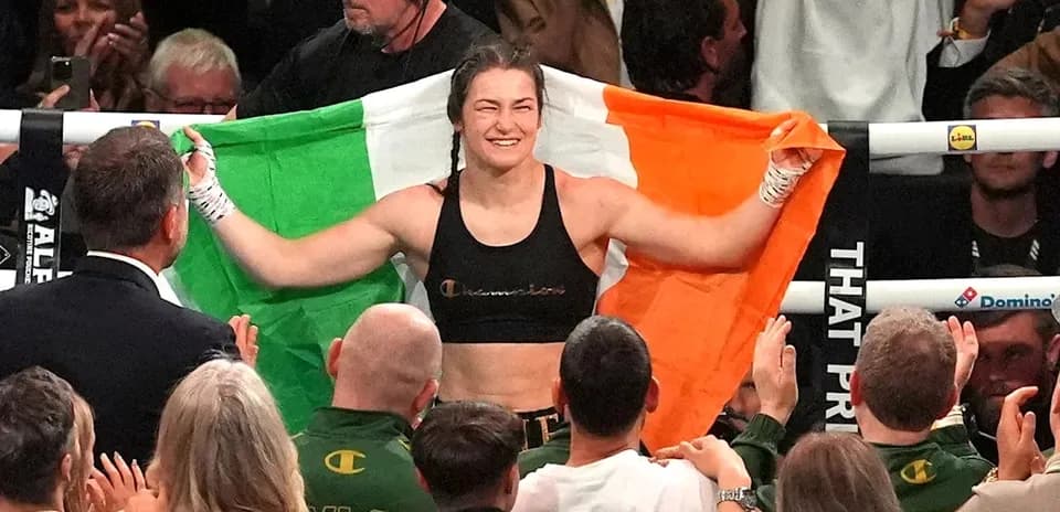Female boxer celebrating with Irish flag after victory